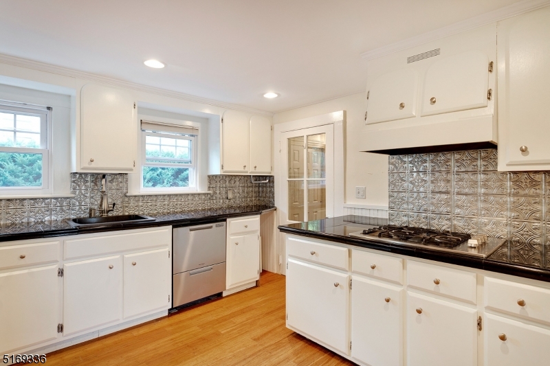 62 Crane Street Caldwell, NJ 07006 - Photo 11 of 28 a kitchen with granite countertop white cabinets white appliances and a wide window