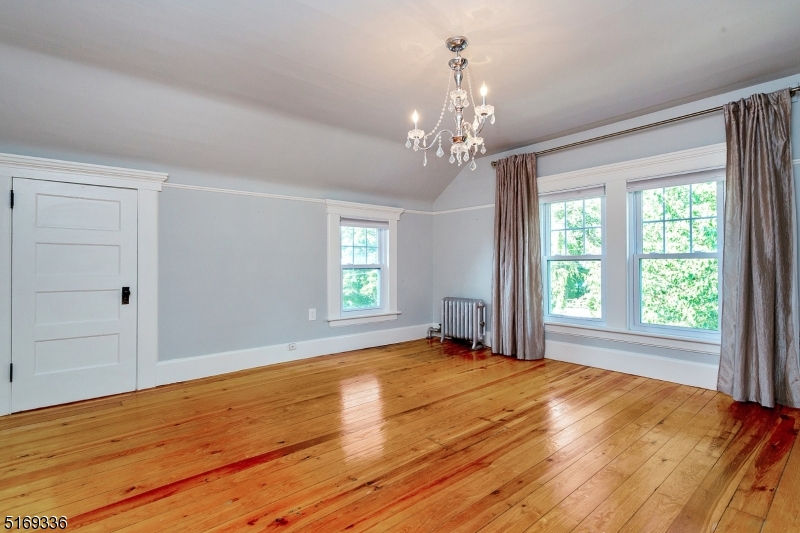 62 Crane Street Caldwell, NJ 07006 - Photo 12 of 28 a view of an empty room with a window and wooden floor