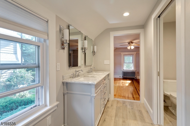 62 Crane Street Caldwell, NJ 07006 - Photo 16 of 28 a en suite bathroom with a granite countertop sink and a mirror