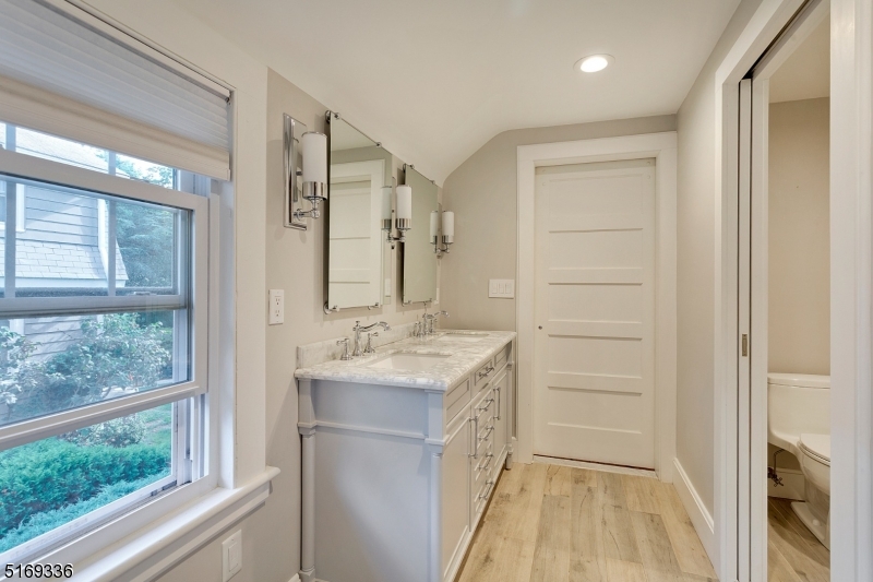 62 Crane Street Caldwell, NJ 07006 - Photo 17 of 28 a bathroom with a sink a mirror and a shower