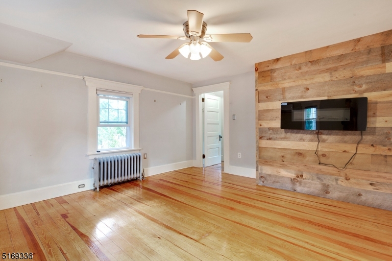 62 Crane Street Caldwell, NJ 07006 - Photo 19 of 28 a view of livingroom with hardwood floor and flat screen tv