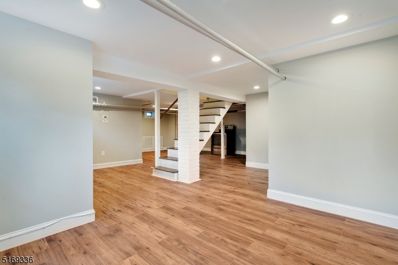 62 Crane Street Caldwell, NJ 07006 - Photo 22 of 28 an empty room with wooden floor and staircase