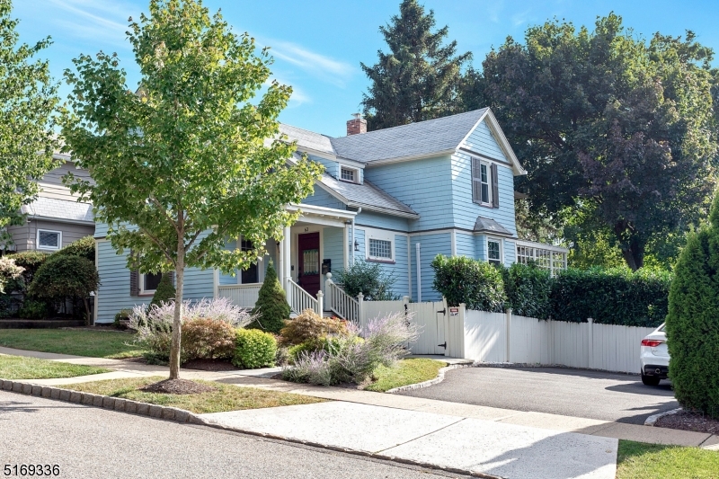 62 Crane Street Caldwell, NJ 07006 - Photo 28 of 28 a view of a white house with a small yard plants and large trees