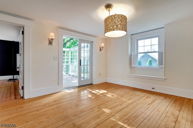 62 Crane Street Caldwell, NJ 07006 - Photo 5 of 28 an empty room with wooden floor fan and windows
