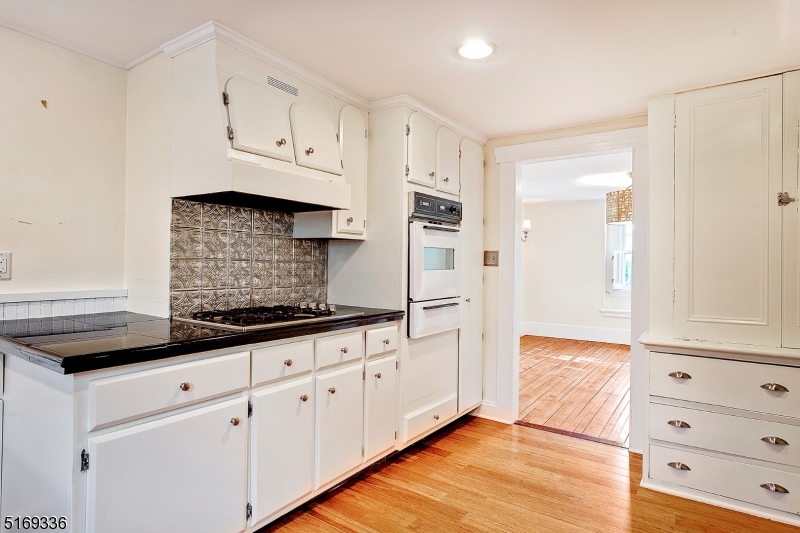 62 Crane Street Caldwell, NJ 07006 - Photo 10 of 28 a kitchen with granite countertop white cabinets and stainless steel appliances