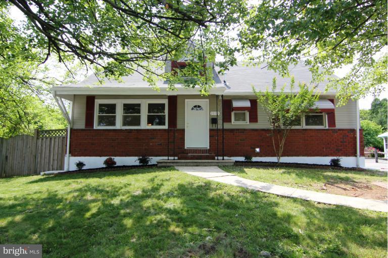 2038 Rolling Rd. Windsor Mill, MD 21244 - Photo 1 of 16 a view of a house with a yard and a large tree