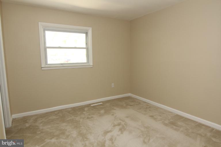 2038 Rolling Rd. Windsor Mill, MD 21244 - Photo 3 of 16 an empty room with a window