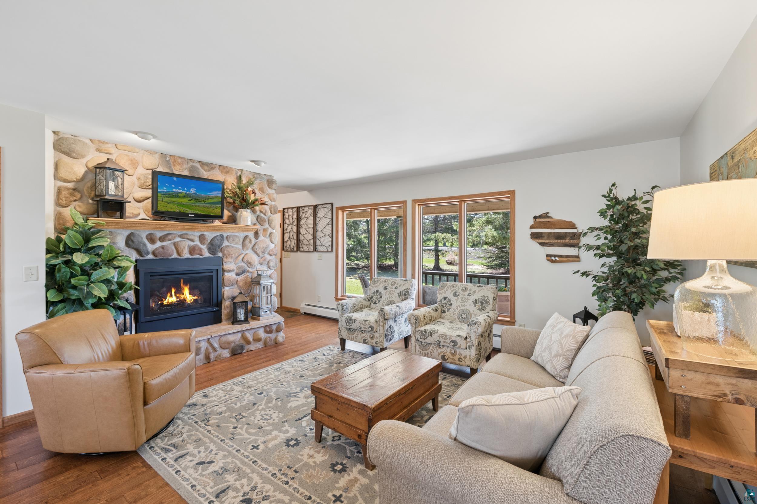 3113 Golf Course Road Ashland, WI 54806 - Photo 12 of 38 Stone-clad fireplace with hearth and wood mantel