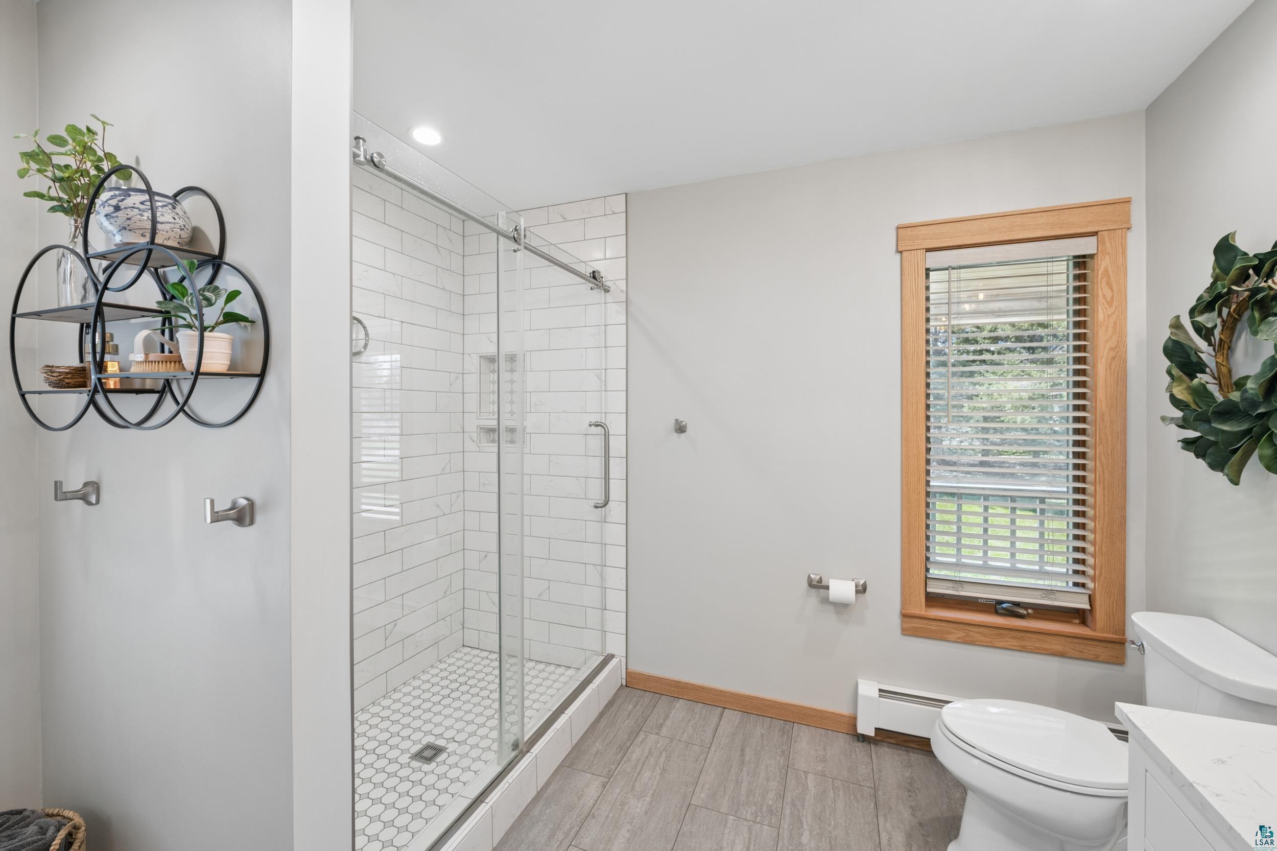 3113 Golf Course Road Ashland, WI 54806 - Photo 20 of 38 Glass-enclosed shower featuring white subway tile surround and a hexagonal tile floor