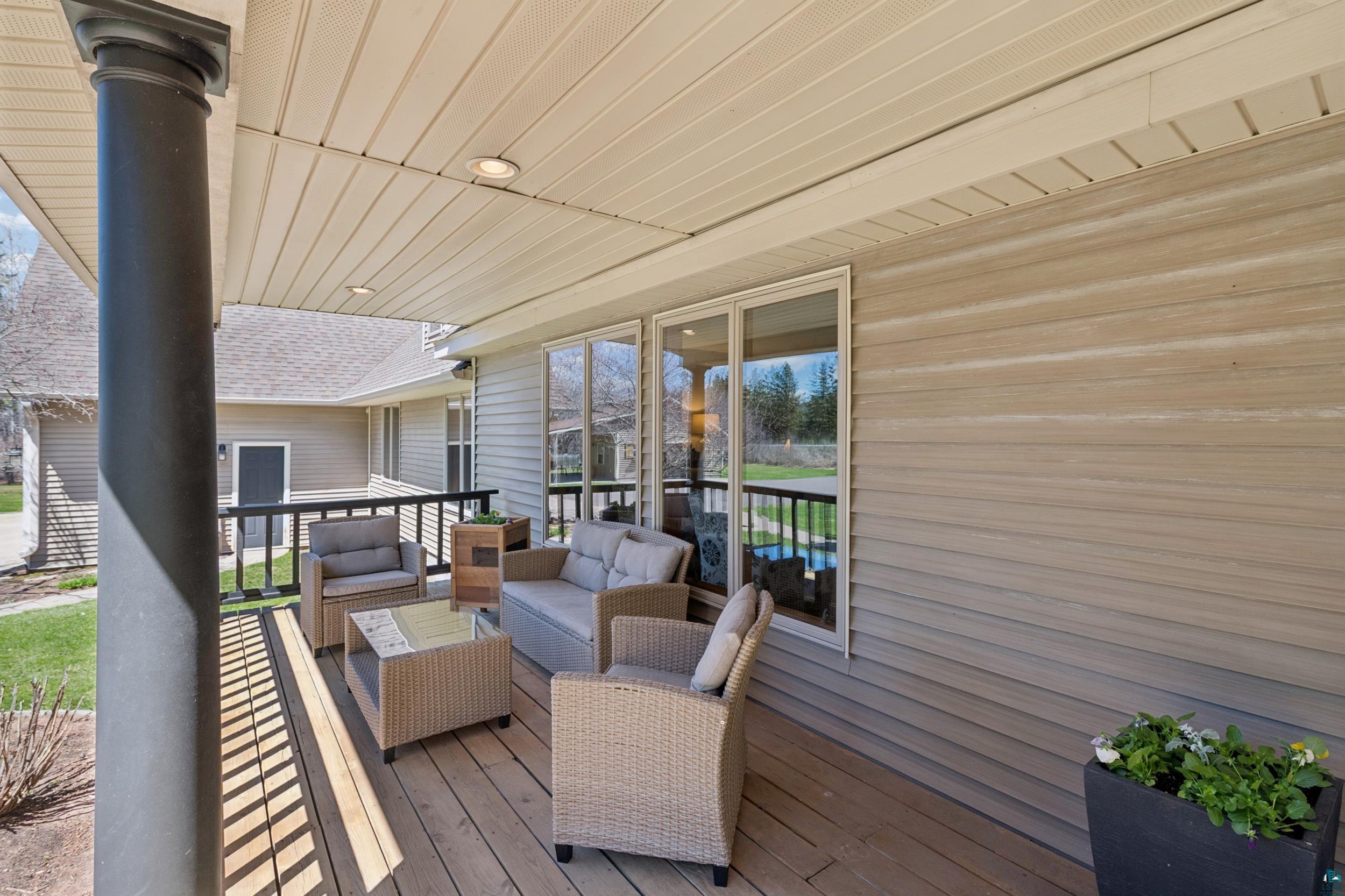 3113 Golf Course Road Ashland, WI 54806 - Photo 31 of 38 Covered porch featuring a composite deck, recessed lighting, and a black spindle railing