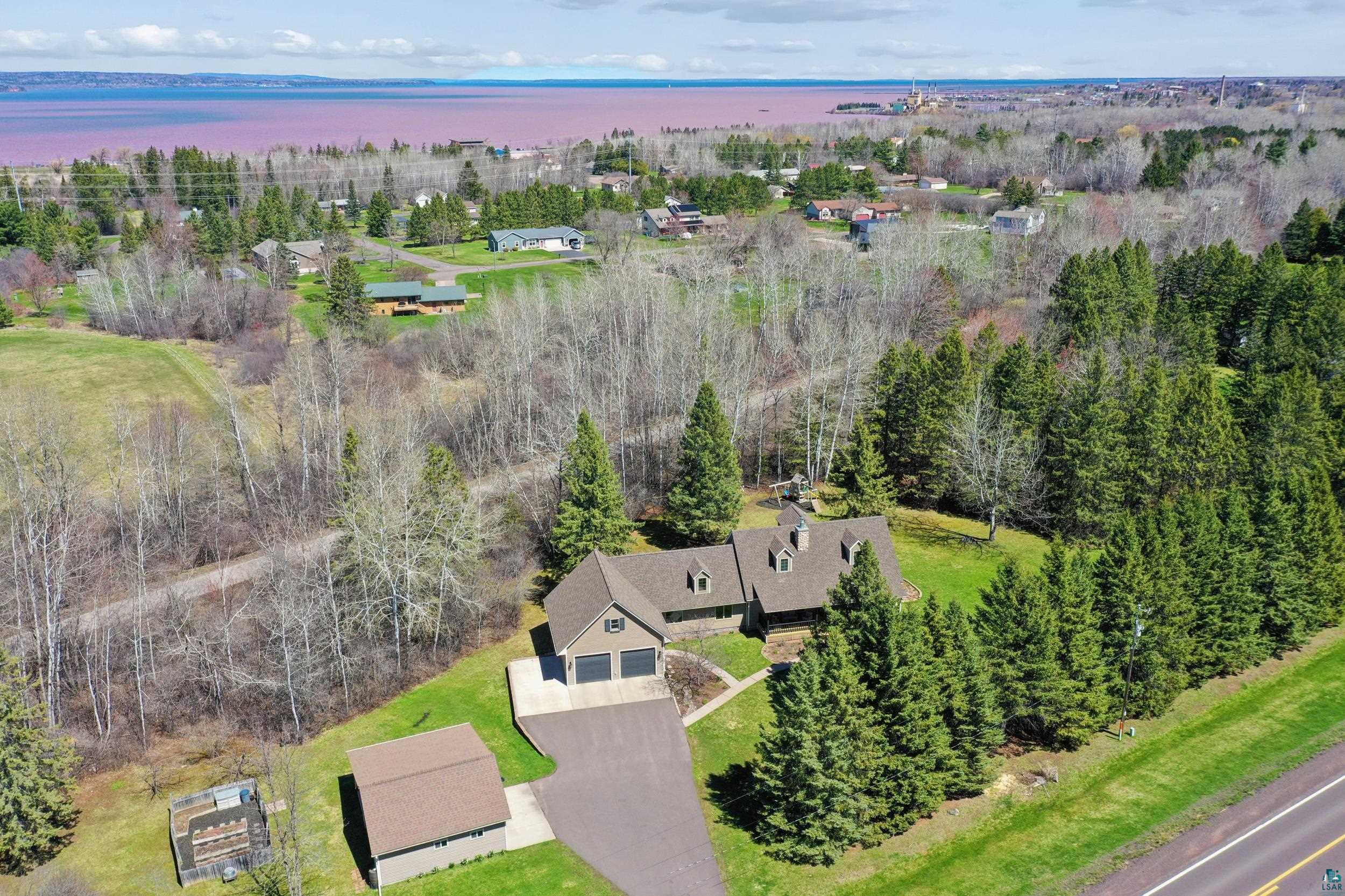 3113 Golf Course Road Ashland, WI 54806 - Photo 38 of 38 Aerial perspective of a property featuring a multi-gable roofline, a paved driveway, and a detached outbuilding