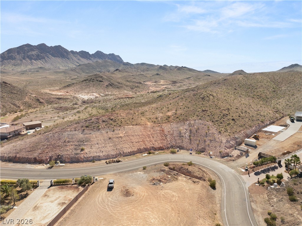A panoramic vista reveals sweeping desert landscapes and distant mountains under a clear sky.