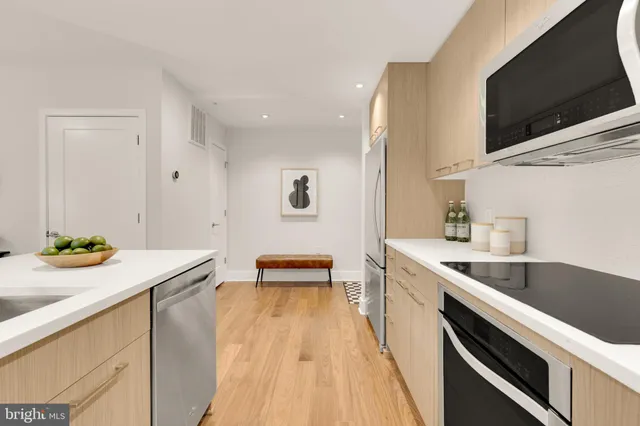 a kitchen with a sink and wooden floor