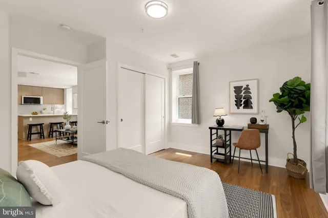 a bedroom with furniture and a wooden floor