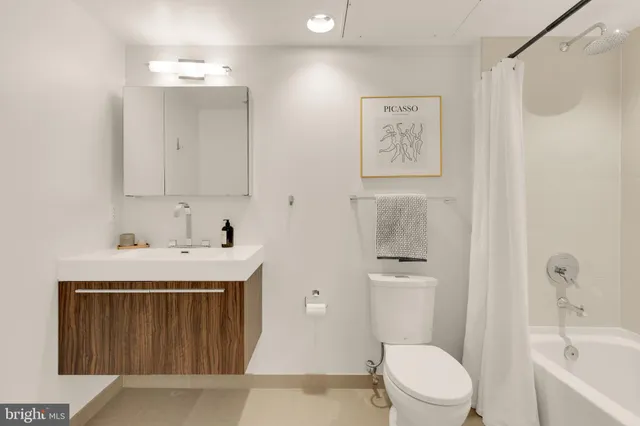 a white toilet sitting next to a bathroom sink