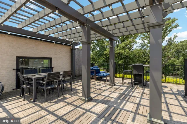 a view of a porch with chairs and potted plants
