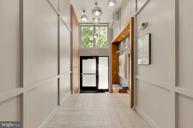a view of an entryway with wooden floor and windows