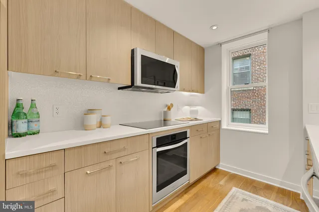 a kitchen with a sink and a stove top oven