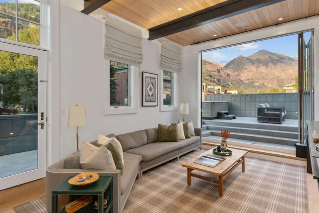 a living room with furniture and a floor to ceiling window