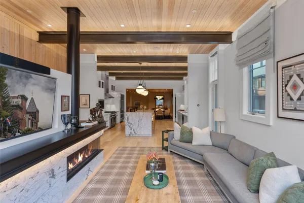 a living room with furniture and a floor to ceiling window