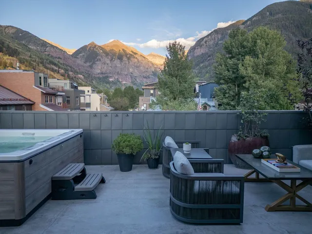 a backyard of a house with outdoor seating