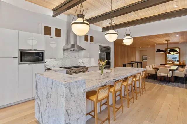 a large kitchen with a table and chairs