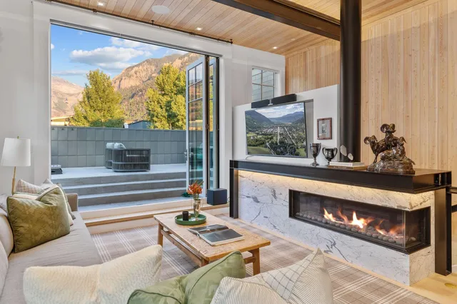 a living room with furniture and a floor to ceiling window