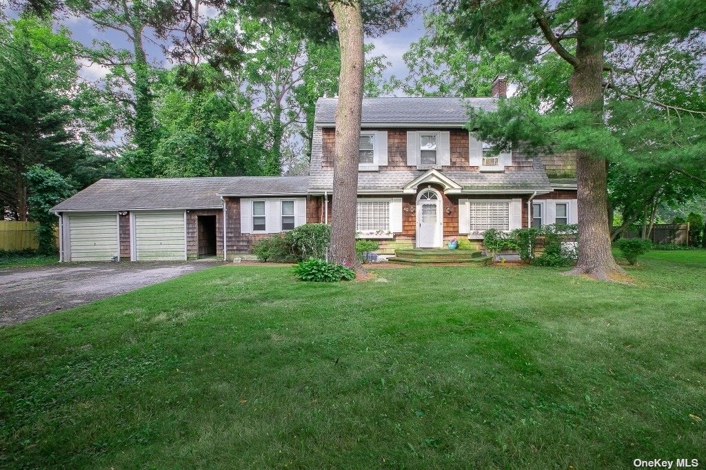 40 La Rue Drive Huntington, NY 11743 - Photo 1 of 1 a front view of a house with a garden and yard