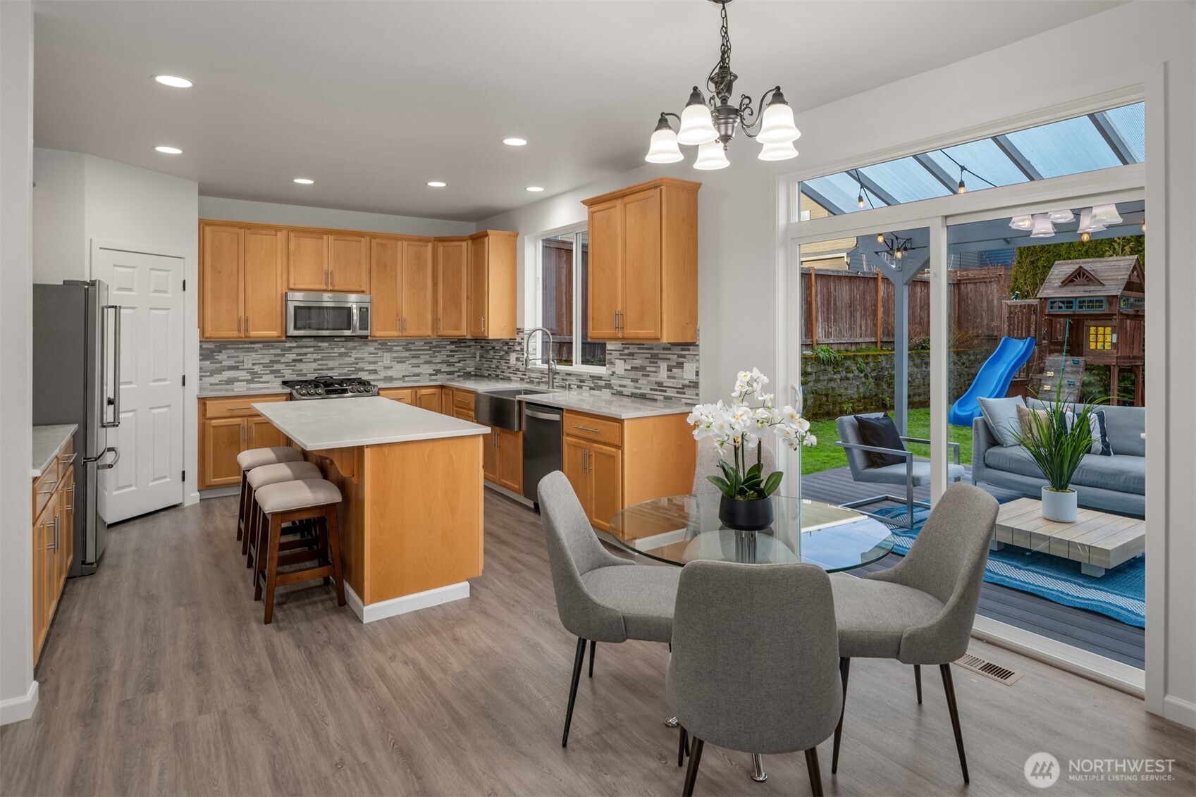 21120 Meridian Place West Bothell, WA 98021 - Photo 12 of 36 a dining room filled chandelier and wooden floor