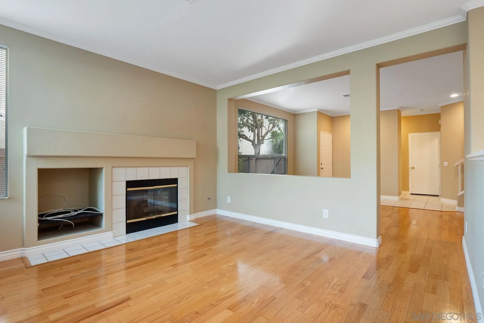5512 Renaissance Avenue, Unit 3 San Diego, CA 92122 - Photo 13 of 57 a view of an empty room with a fireplace and a window
