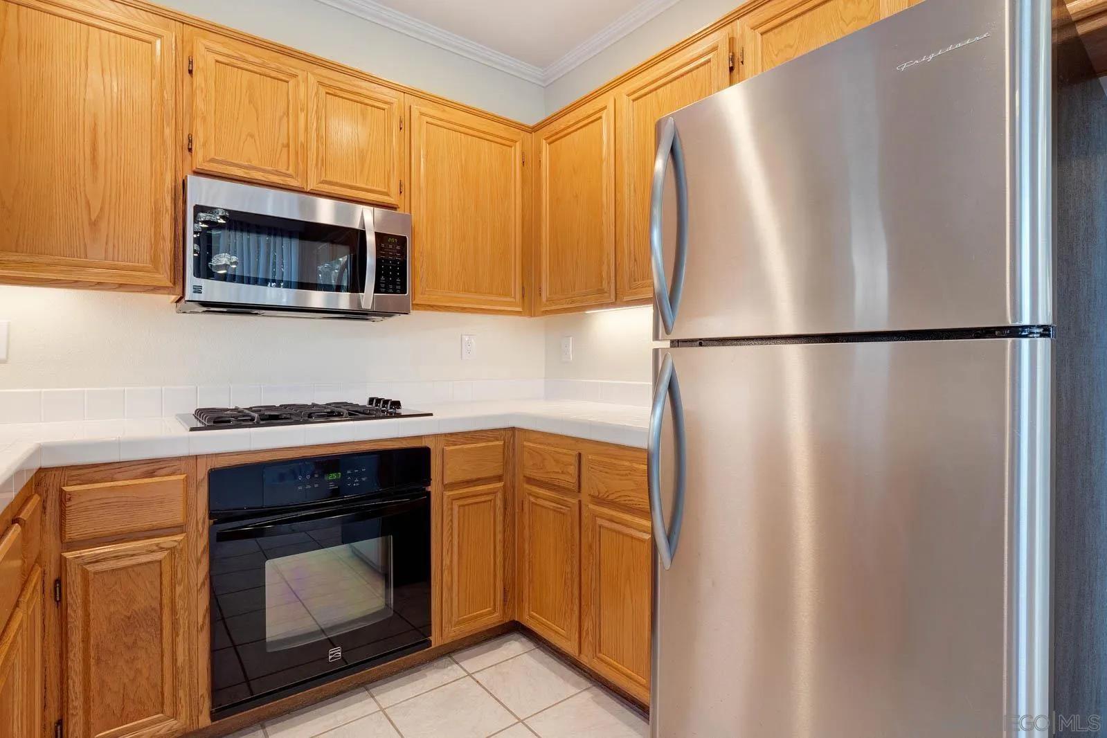 5512 Renaissance Avenue, Unit 3 San Diego, CA 92122 - Photo 17 of 57 a kitchen with a refrigerator sink and microwave