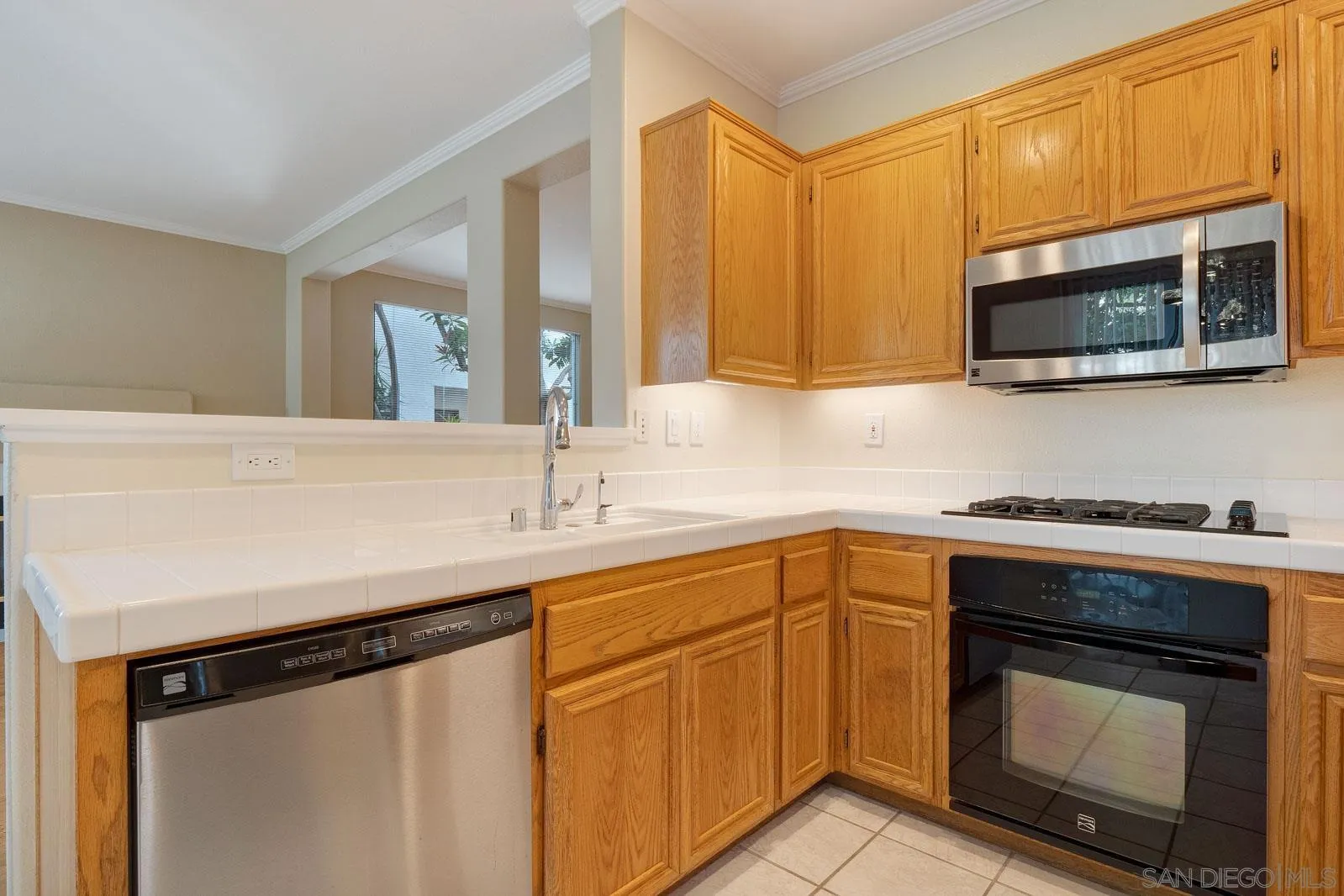 5512 Renaissance Avenue, Unit 3 San Diego, CA 92122 - Photo 18 of 57 a kitchen with stainless steel appliances a stove microwave and sink