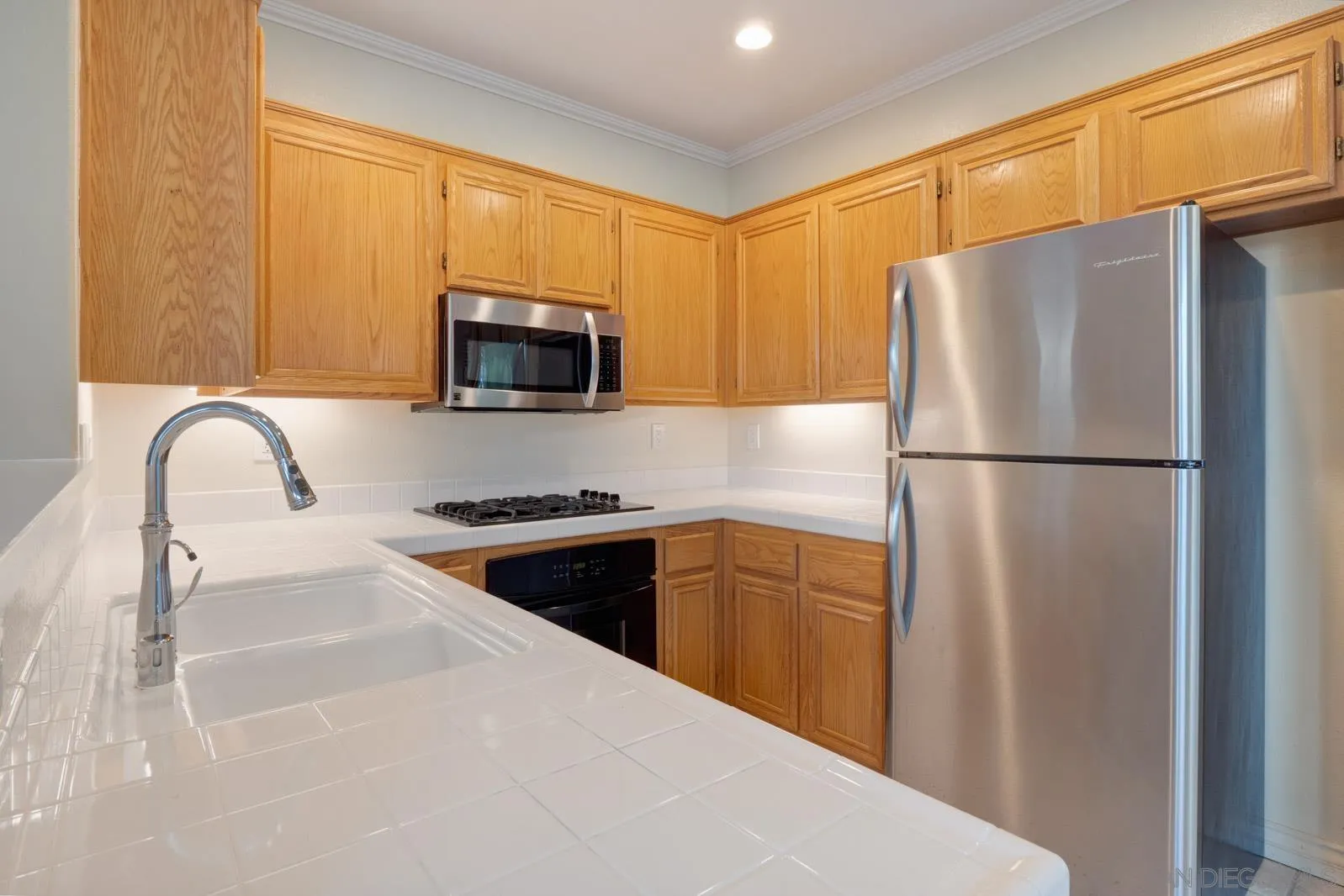 5512 Renaissance Avenue, Unit 3 San Diego, CA 92122 - Photo 20 of 57 a kitchen with a refrigerator sink and microwave