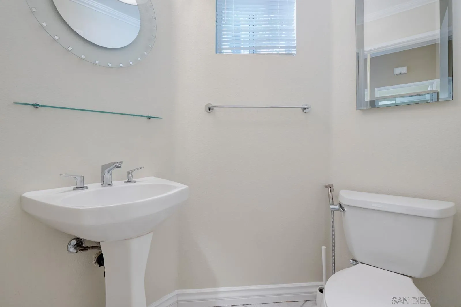 5512 Renaissance Avenue, Unit 3 San Diego, CA 92122 - Photo 21 of 57 a bathroom with a toilet sink and mirror