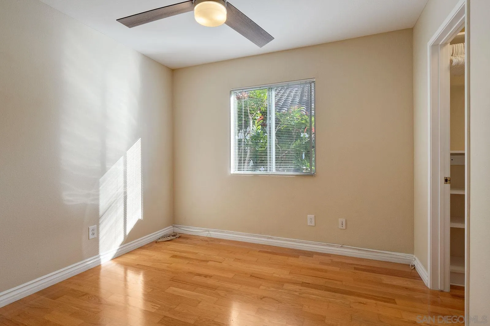 5512 Renaissance Avenue, Unit 3 San Diego, CA 92122 - Photo 26 of 57 an empty room with wooden floor and windows