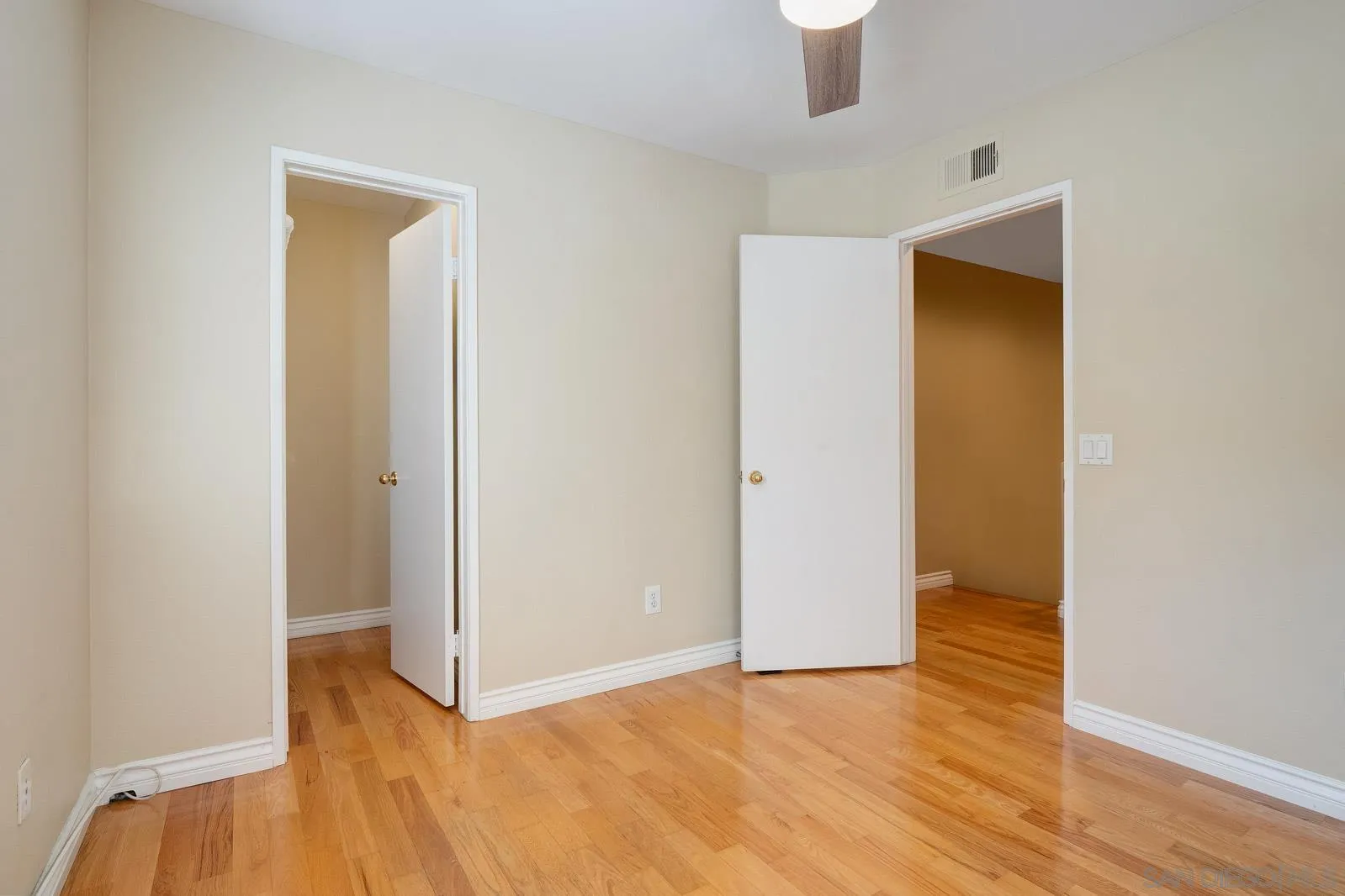 5512 Renaissance Avenue, Unit 3 San Diego, CA 92122 - Photo 29 of 57 a view of an empty room with wooden floor and a window