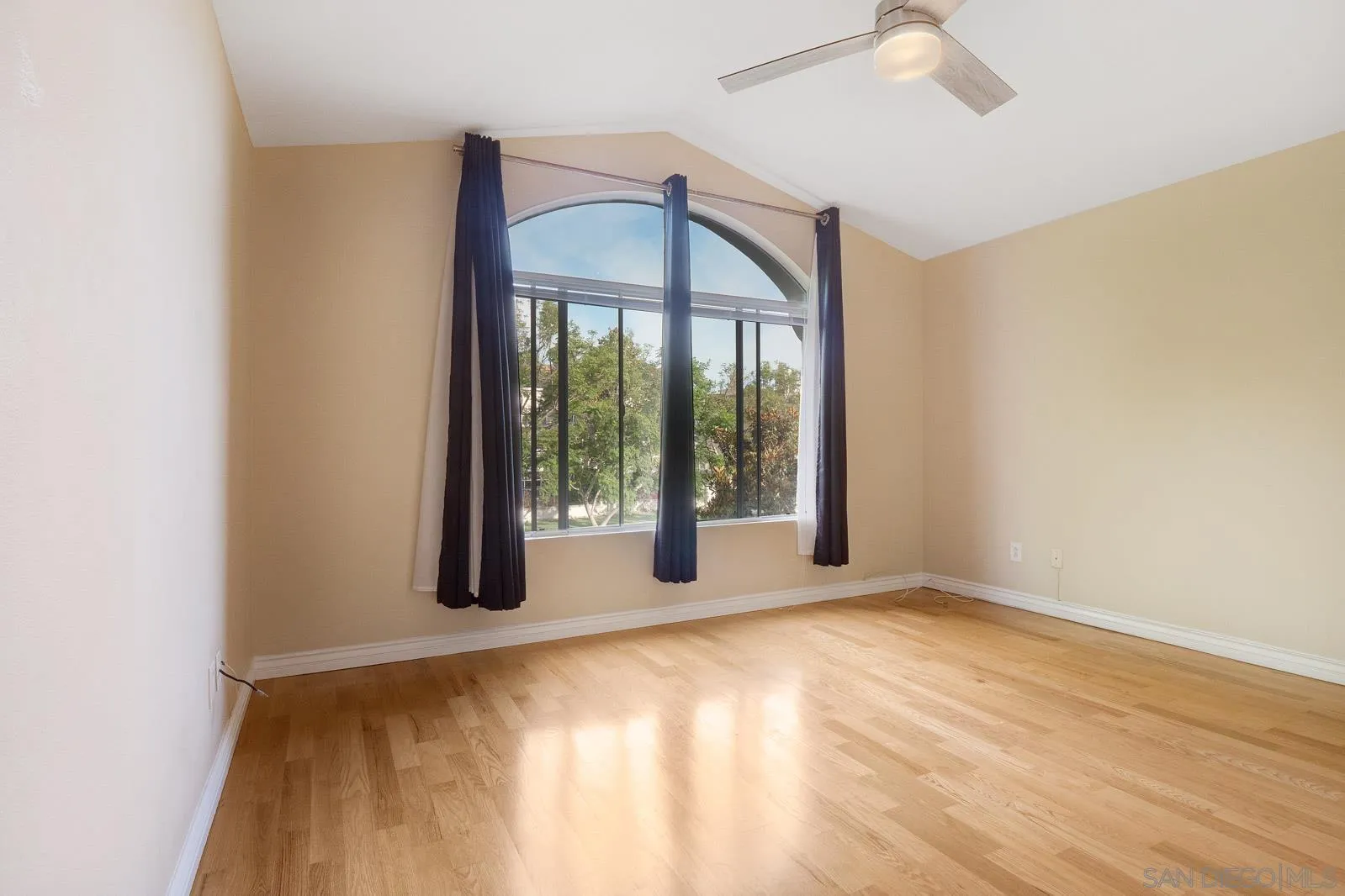 5512 Renaissance Avenue, Unit 3 San Diego, CA 92122 - Photo 31 of 57 a view of an empty room with wooden floor and a window