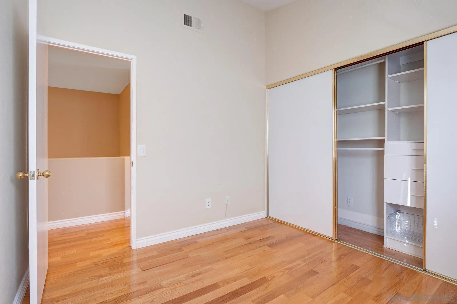 5512 Renaissance Avenue, Unit 3 San Diego, CA 92122 - Photo 37 of 57 a view of an empty room with wooden floor and closet