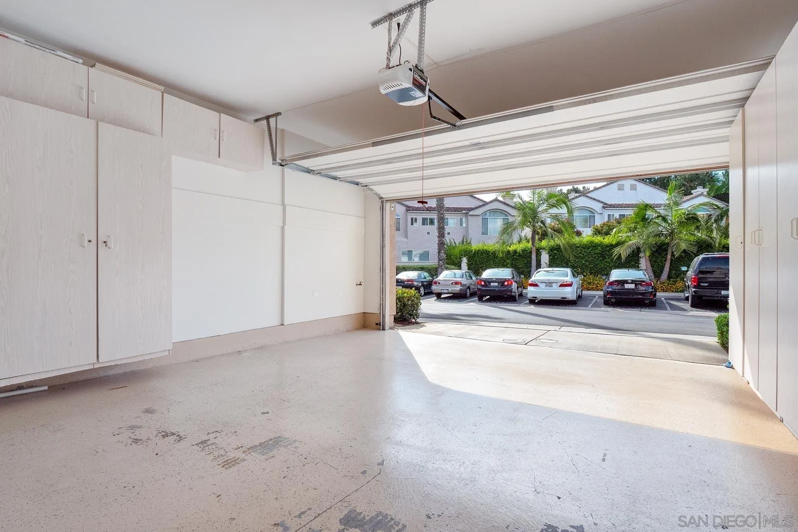 5512 Renaissance Avenue, Unit 3 San Diego, CA 92122 - Photo 39 of 57 a view of a room with furniture and floor to ceiling window