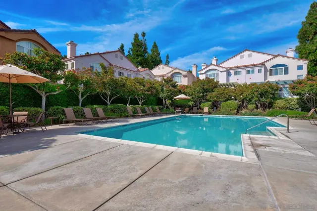 a view of a house with a yard and sitting area