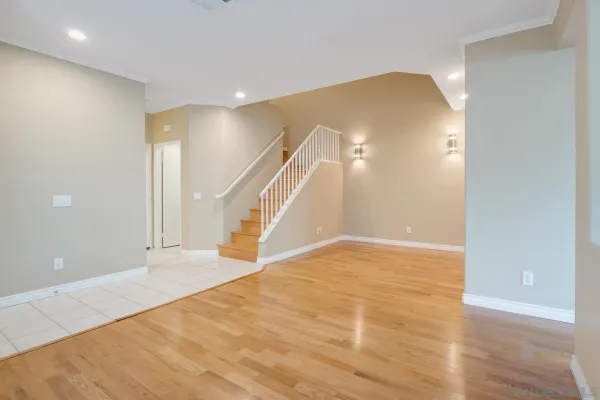 a view of empty room with wooden floor and fireplace