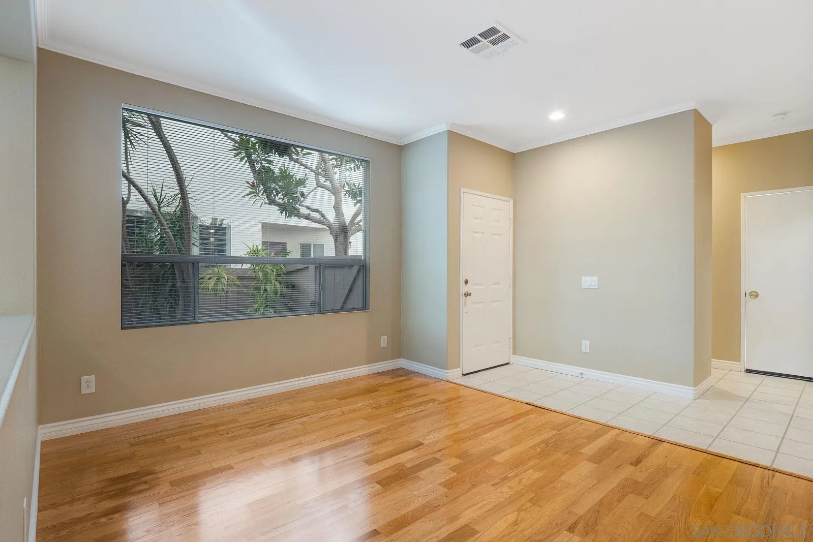 5512 Renaissance Avenue, Unit 3 San Diego, CA 92122 - Photo 9 of 57 a view of empty room with wooden floor and fan