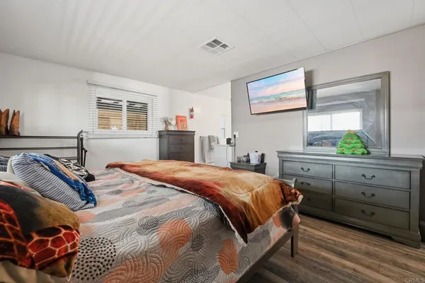 a bedroom with a bed and a dresser