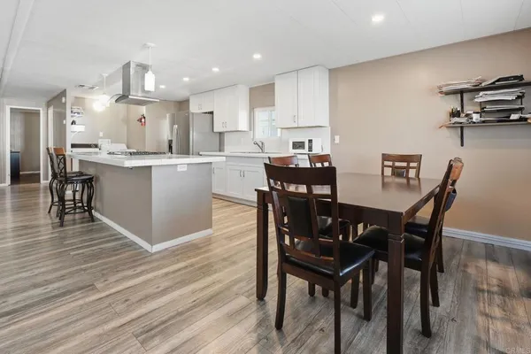 a view of kitchen with cabinets table and chairs