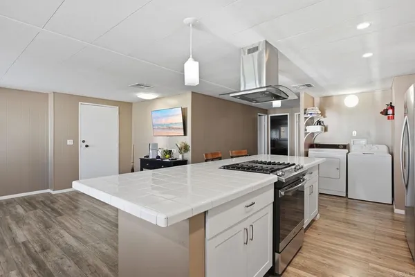 a kitchen that has a stove and a table