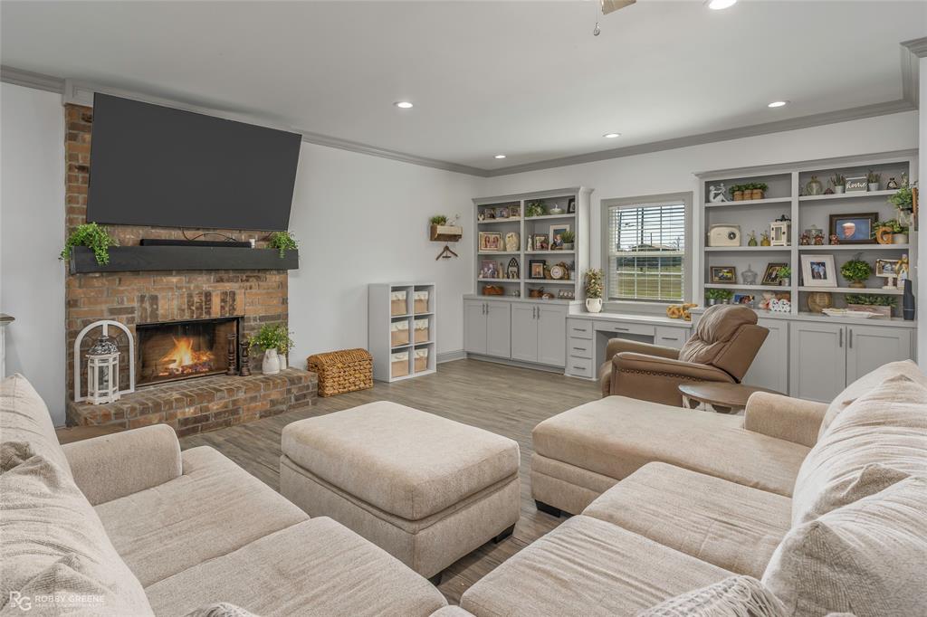 396 Collinswood Road Stonewall, LA 71078 - Photo 10 of 32 a living room with furniture and a fireplace