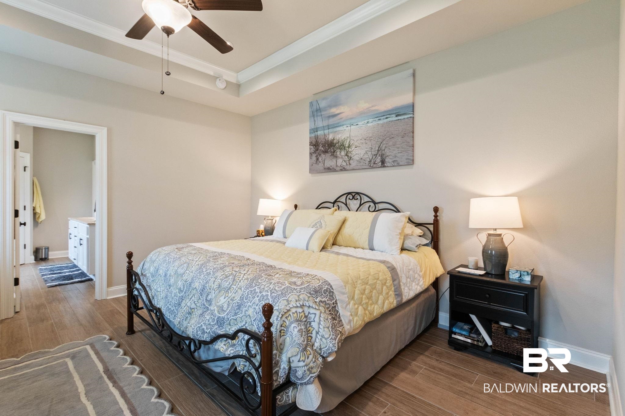 22244 Hibiscus Circle Foley, AL 36535 - Photo 43 of 51 Recessed ceiling with crown molding, wood-finish flooring, and a ceiling fan with integrated lighting