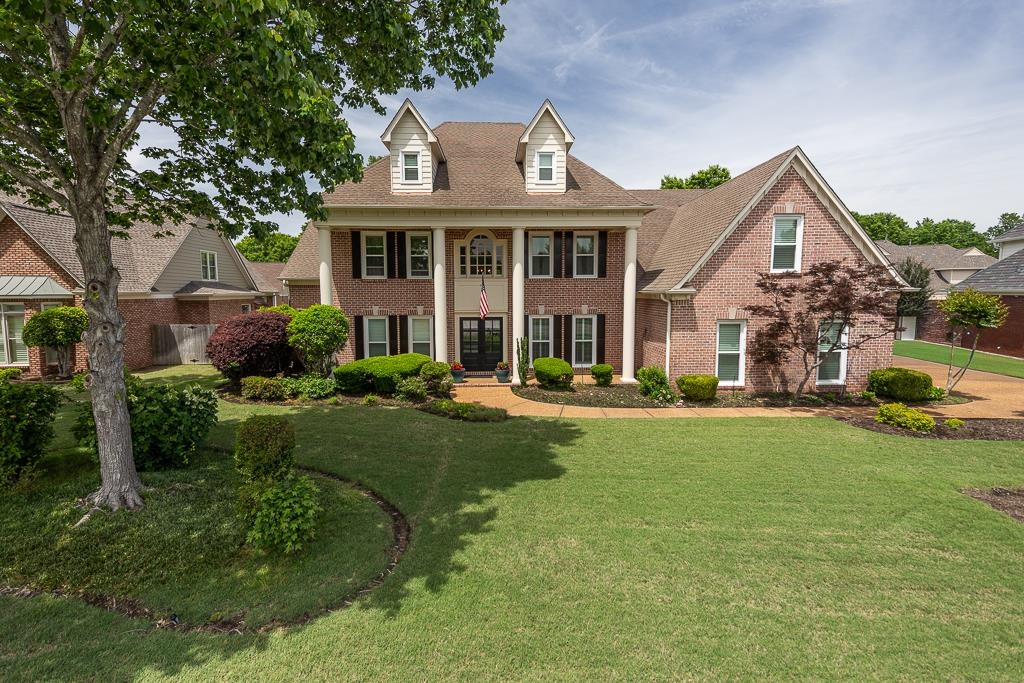1725 John Ridge Drive Collierville, TN 38017 - Photo 1 of 34 a front view of a house with a yard and porch