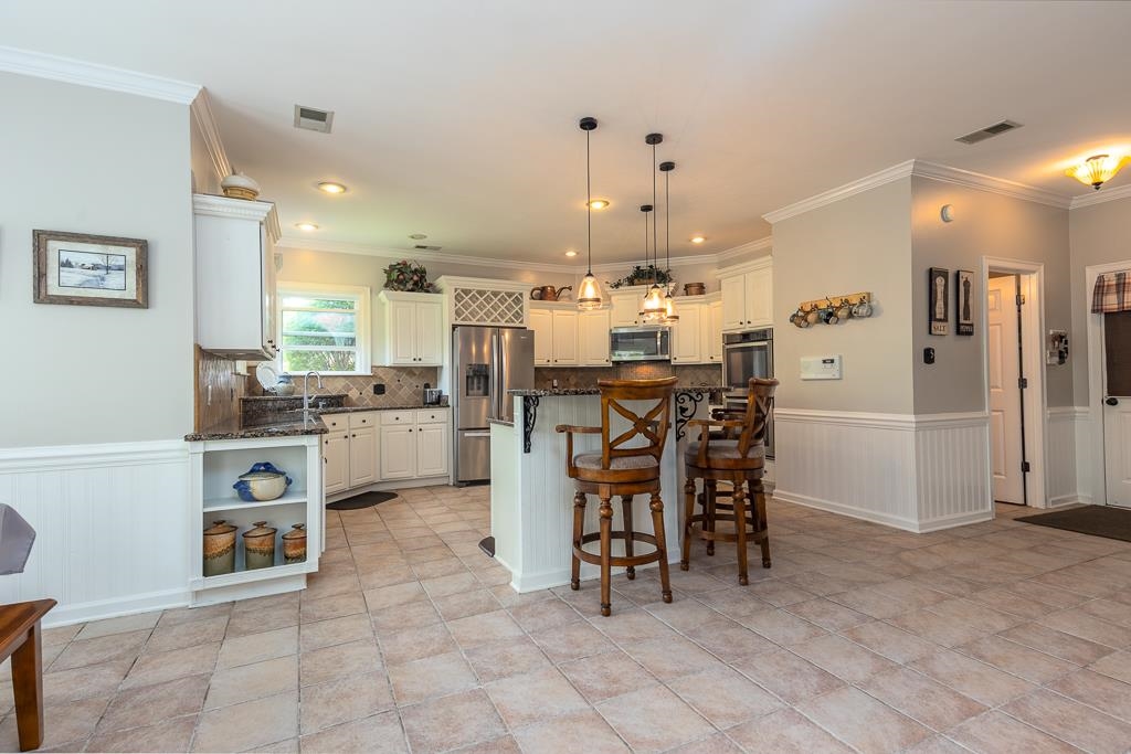 1725 John Ridge Drive Collierville, TN 38017 - Photo 15 of 34 a kitchen with stainless steel appliances kitchen island granite countertop a refrigerator and cabinets