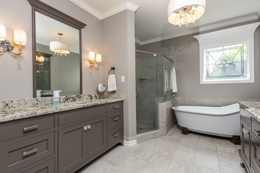 1725 John Ridge Drive Collierville, TN 38017 - Photo 20 of 34 a bathroom with a granite countertop sink a toilet a mirror and bathtub